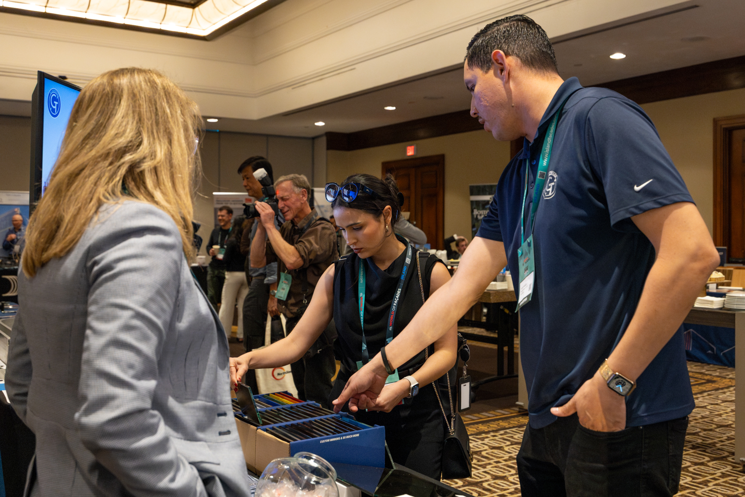 Glasswerks glass fabrication team speaking with a delegate at our Zak World of Façades Los Angeles 2026 exhibit.